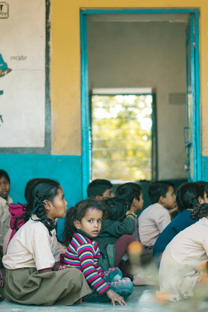 Children in a classroom setting, actively participating in a learning environment in an Indian school.